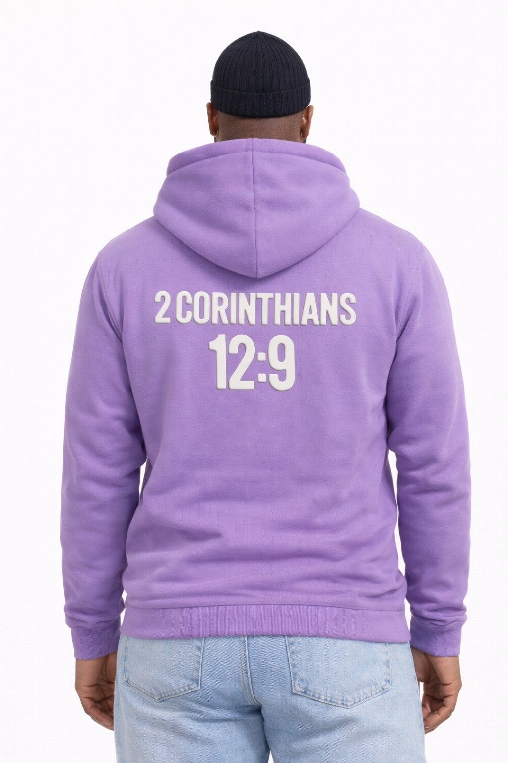 Person wearing a purple hoodie with '2 Corinthians 12:9' printed on the back, standing against a white background.