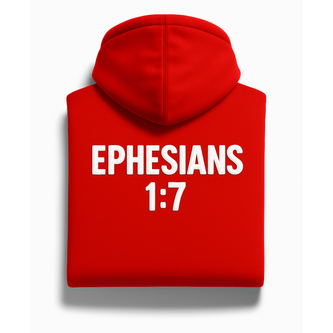 Folded red Covenant satin-lined hoodie from Savior Brand, featuring bold white “Ephesians 1:7” Bible verse design on the back.